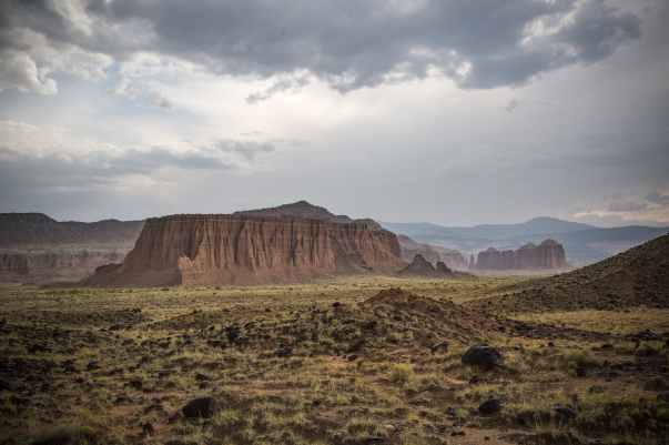 scenic view of desert landscape against dramatic sky